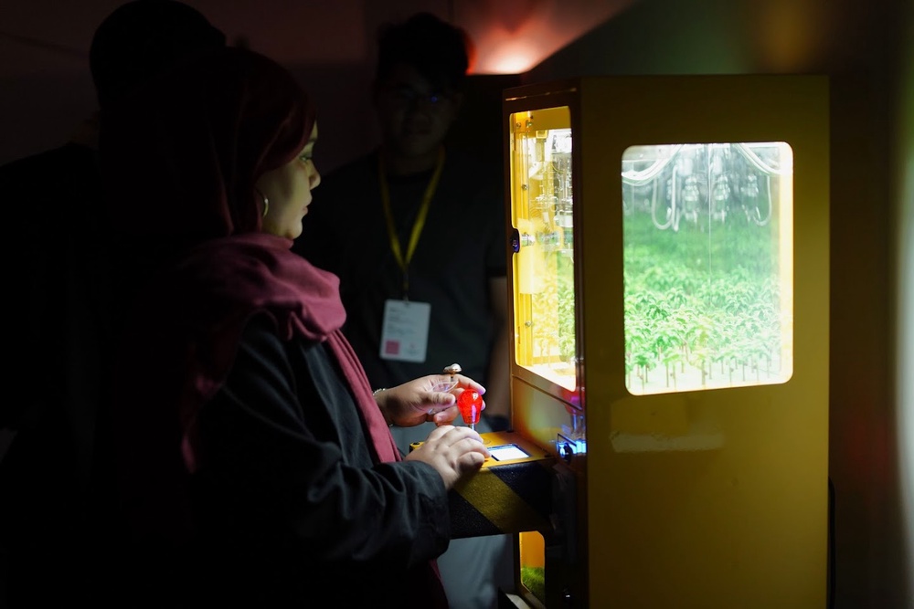 Visitors interacting with miniature artworks at Sim Chan's The Infinite-land exhibition