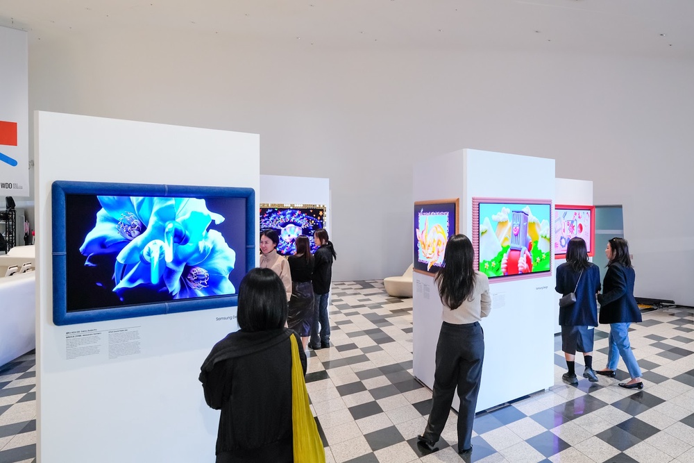 Custom-framed Samsung S95H OLED TVs displaying artwork at Design is an Act of Love exhibition