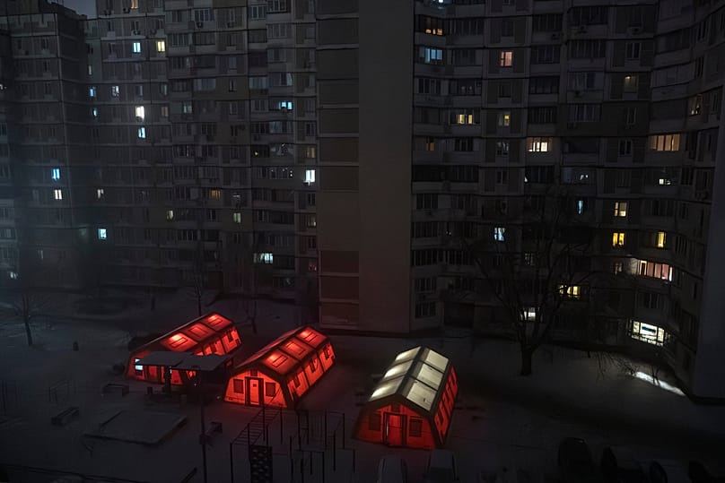 Emergency tents are set up in a residential neighbourhood where people can warm up following air attacks in Kyiv, 15 January, 2026