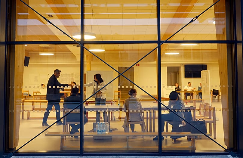 A man prepares his ballot for a presidential election at a poling station in Ljubljana, 23 October, 2022