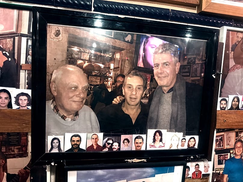The owner of the Tasca with Portuguese writer António Lobo Antunes and US chef and TV host Anthony Bourdain (photo displayed on site)