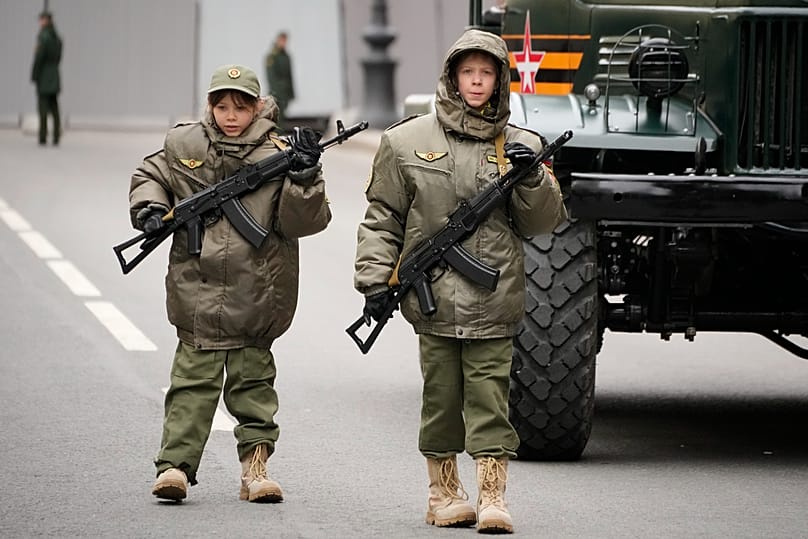 FILE: Children, participants of the parade walk, prior to a rehearsal for the Victory Day military parade at Dvortsovaya Square in St. Petersburg, Russia, May 5, 2024.
