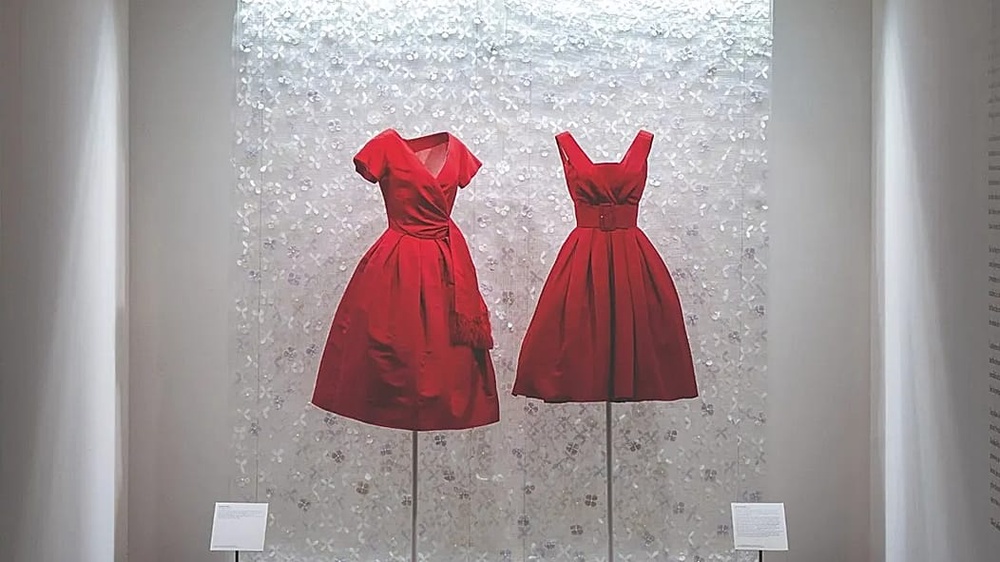 From left: Dior's Boutique, c 1957, red silk cocktail dress and Alaïa's Haute Couture, 1958 - Formal afternoon dress 
