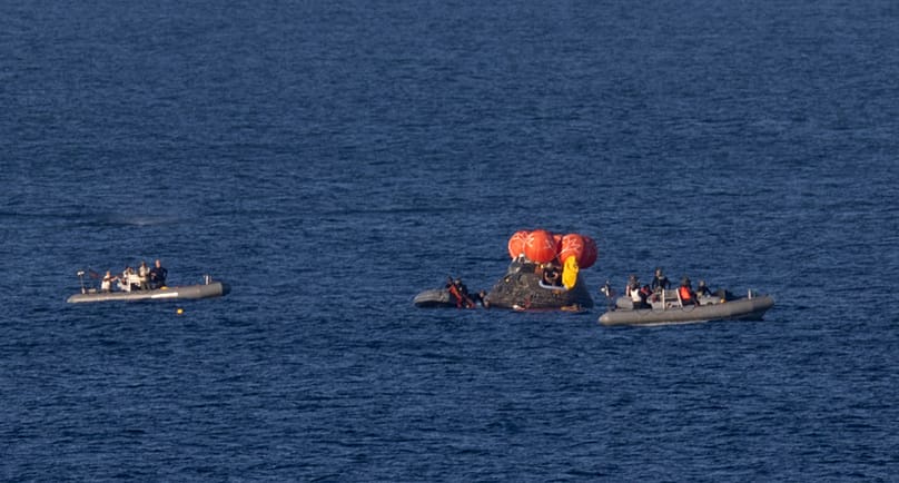 In this photo provided by NASA, recovery teams work to secure the Orion spacecraft carrying Artemis II crewmembers after splashdown in the Pacific Ocean off the coast of Cali.