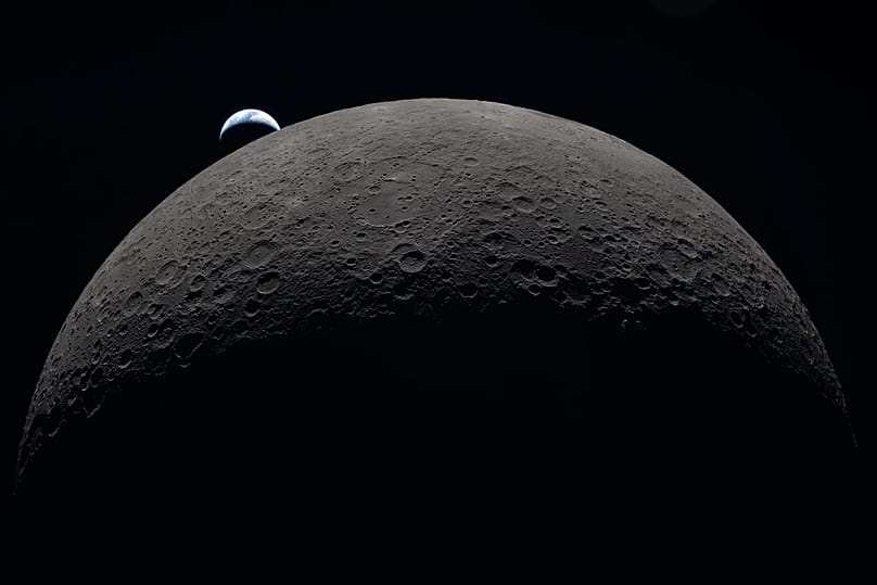 In this image provided by NASA, the Artemis II crew captured this view as the Earth sets behind the Moon during a lunar flyby, Monday, April 6, 2026. (NASA via AP)