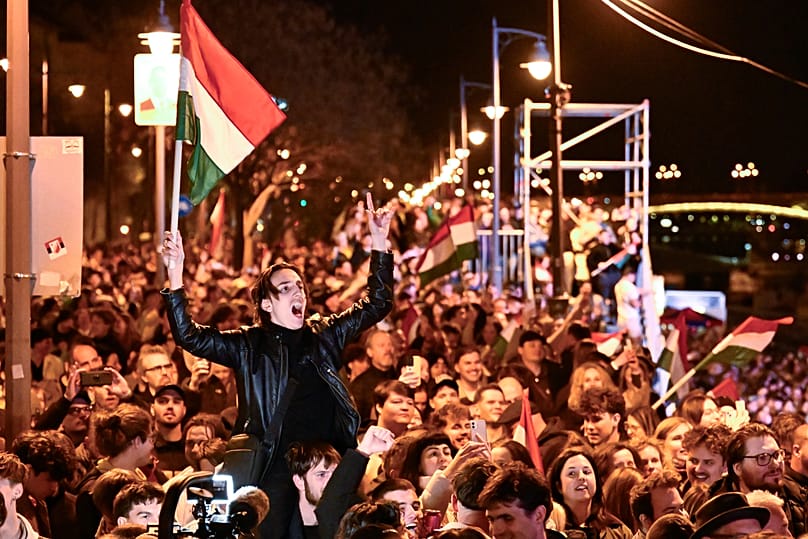 Supporters of Péter Magyar celebrate after a parliamentary election in Budapest, 12 April, 2026