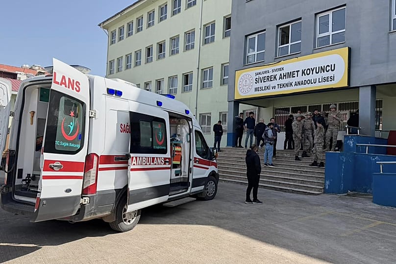 Turkish security forces and emergency staff stand at the courtyard of a high school where an assailant opened fire in Siverek, 14 April, 2026