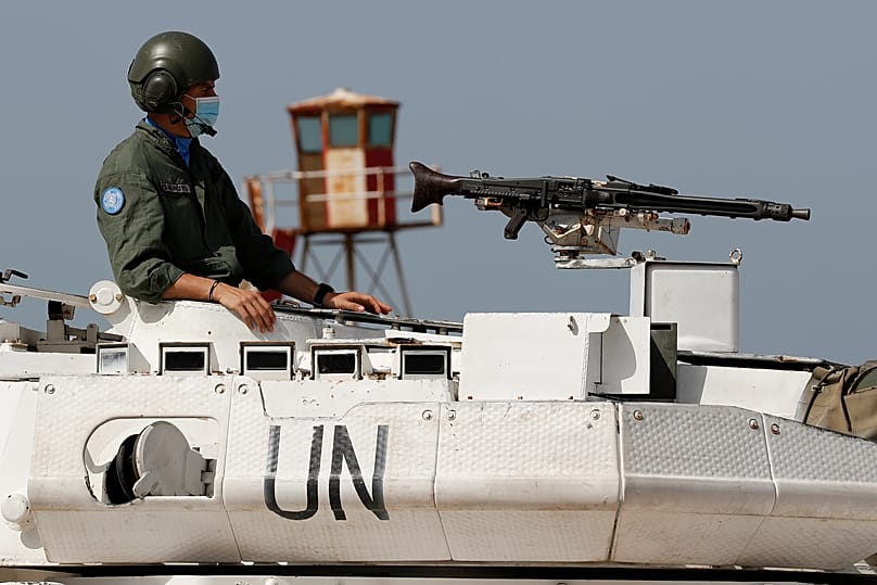 An Italian UN peacekeeping soldier sits on a tank at a road that links to a UNIFIL base in Naqoura, 4 May, 2021