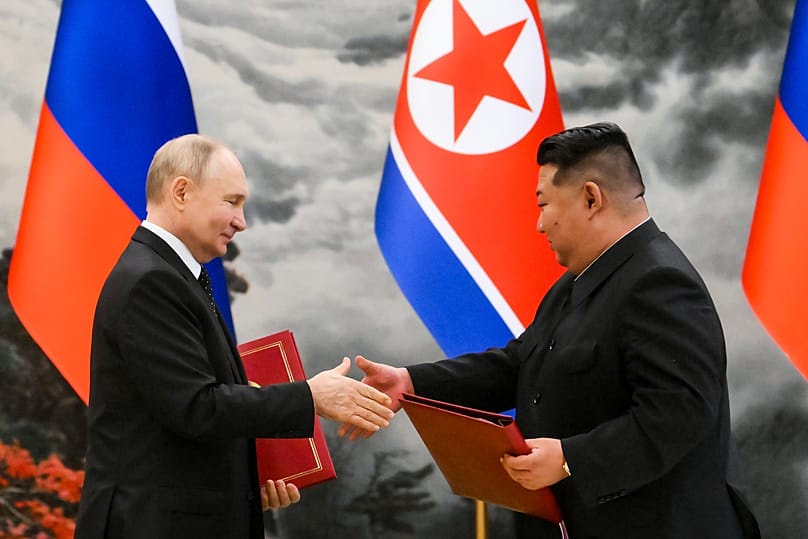 Russian President Vladimir Putin and North Korea's leader Kim Jong Un exchange documents during a signing ceremony in Pyongyang, 19 June, 2024