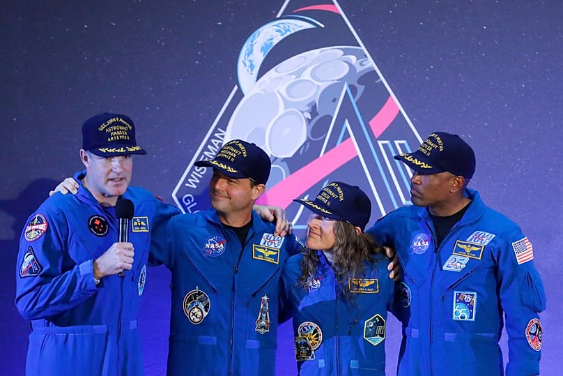 The Artemis II crew, from left, Jeremy Hansen, Reid Wiseman, Christina Koch and Victor Glover gather with Hansen as he speaks during a crew return event Saturday, April 11