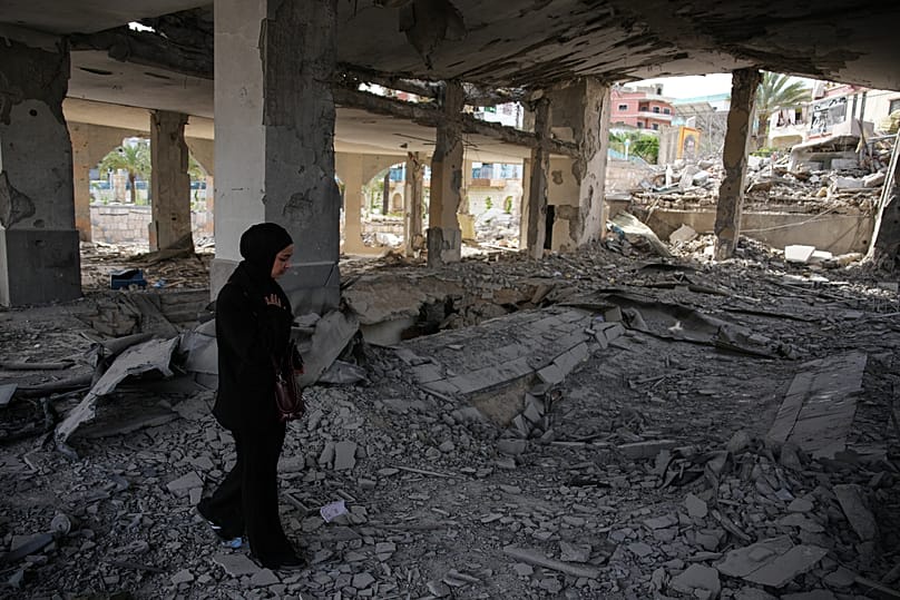 A local resident walks among debris inside a mosque destroyed in an Israeli airstrike in Jibchit, southern Lebanon, Friday, April 17, 2026.