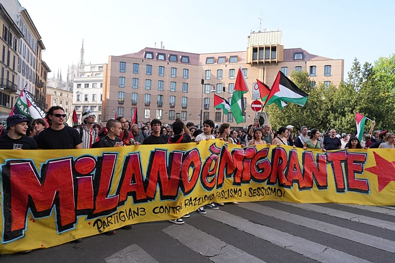 Demonstrators display a banner reading 'Milan is Migrant, Partisans Against Racism, Fascism, ' to protest the anti-migrant rally 'Without Fear in Europe, Milan, 18.04.2026