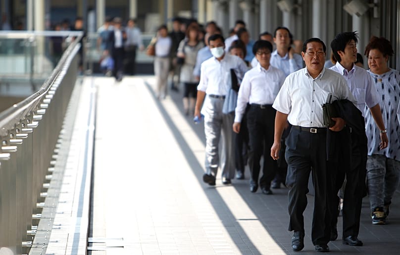 People walk in shade to avoid scorching heat in Tokyo, Wednesday, July 6, 2011. 