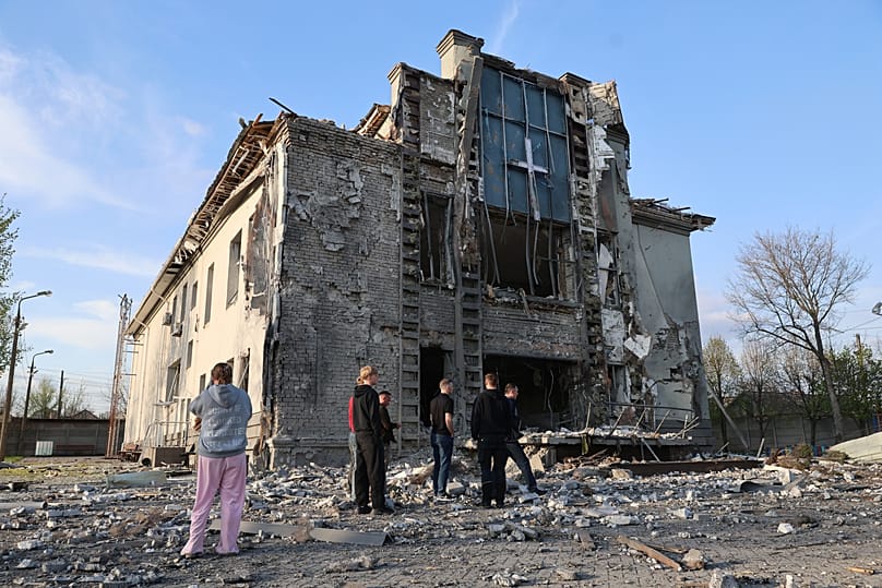 People stand outside a Baptist church damaged by a Russian guided aerial bomb in Zaporizhzhia, 16 April, 2026