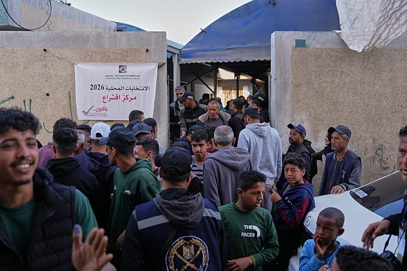 Palestinian men gather in front of a polling station to participate in local elections in Deir al-Balah, central Gaza Strip, Saturday, 25 April, 2026.