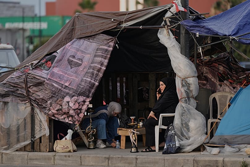 Displaced people who fled Israeli strikes in southern Lebanon sit inside a shelter tent in Beirut, Lebanon, Friday, April 24, 2026. 