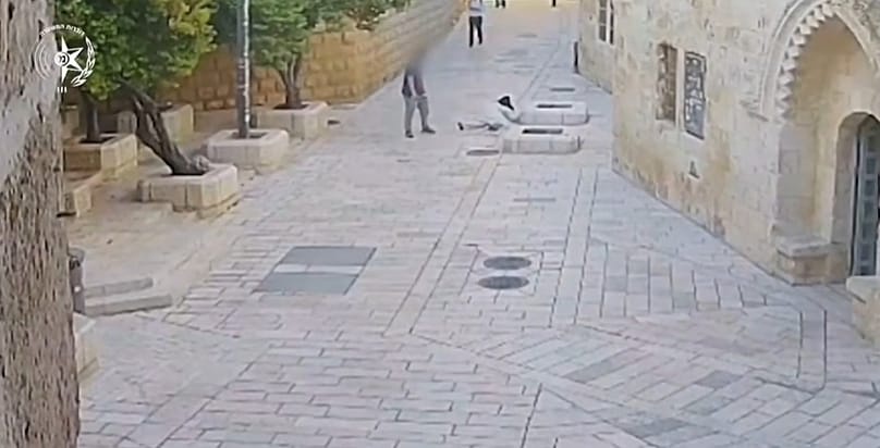 Screenshot of police CCTV video showing a man pushing a French nun to the ground in occupied East Jerusalem