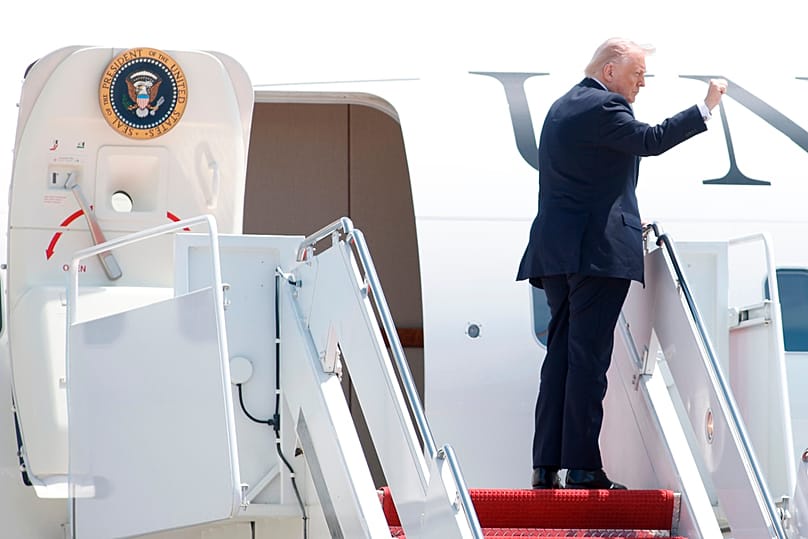 US President Donald Trump gestures as he boards Air Force One, Friday, May 1, 2026, at Joint Base Andrews, Maryland