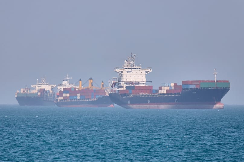 Container ships sit at anchor in the Strait of Hormuz off Bandar Abbas, Iran, May 2, 2026.(Amirhosein Khorgooi/ISNA via AP)