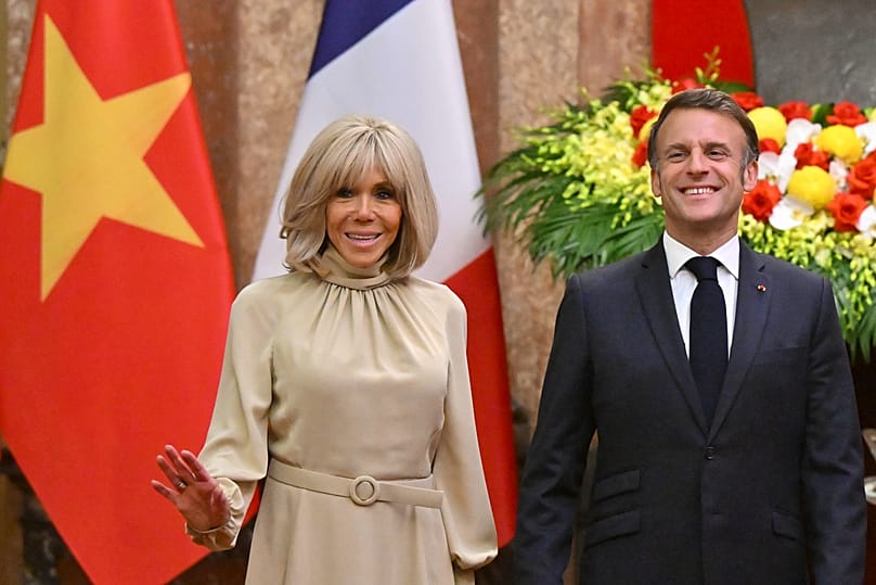 France's President Emmanuel Macron and his wife Brigitte Macron pose for photos at the Presidential Palace in Hanoi, 26 May, 2025