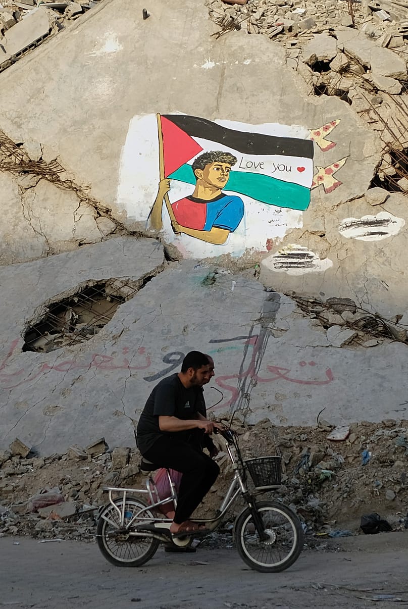 A mural depicting FC Barcelona football player Lamine Yamal holding a Palestinian flag on the rubble of a destroyed building in northern Gaza City, Thursday, 14 May, 2026