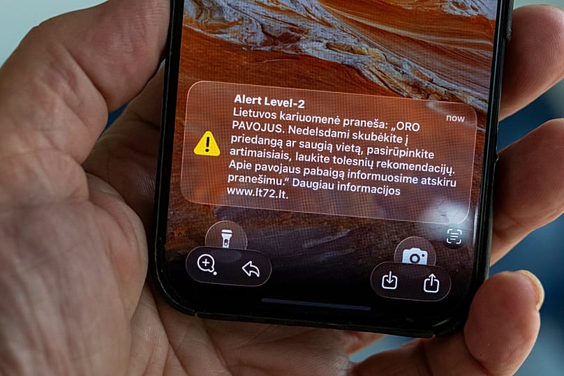 A phone shows an emergency alert message in Vilnius, 20 May, 2026