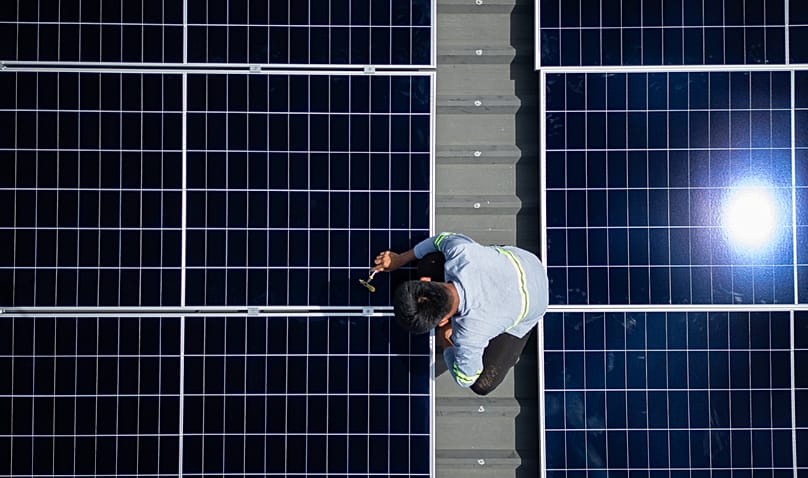 A solar installer secures a solar panel onto the roof of a home in Manila, Philippines, on May 1, 2026