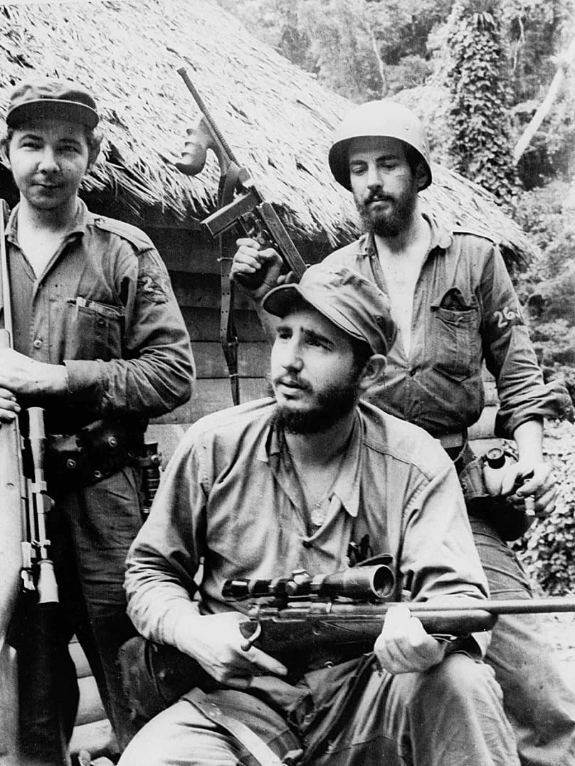 FILE: On 14 March 1957, Fidel Castro, a young anti-Batista guerrilla leader, centre, appears with his brother Raúl Castro, foreground, and Camilo Cienfuegos.