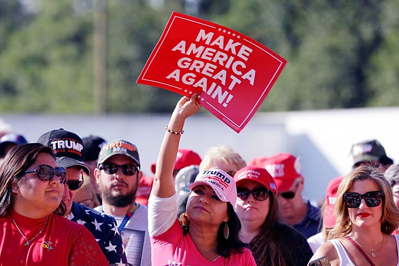 An attendee holds up a MAGA sign as the crowd waits for Donald Trump, Nov. 2, 2023, in Houston. (AP Photo/Michael Wyke)