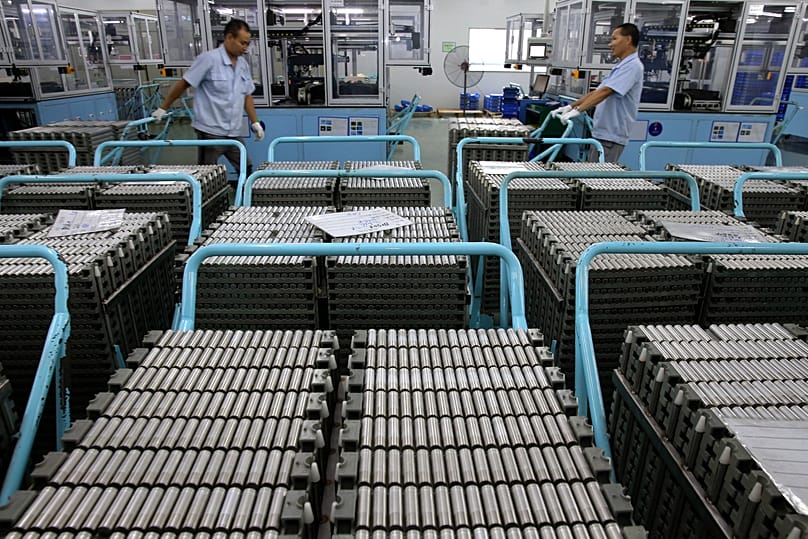 FILE. Workers transfer lithium-ion batteries in a factory in Taizhou in east China's Jiangsu province, Jul. 2018