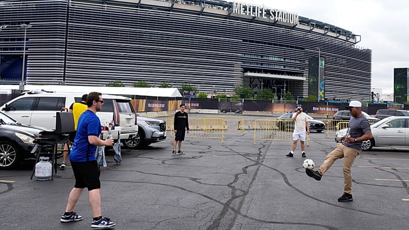 Fans play with a football outside the Metlife Stadium in East Rutherford, New Jersey 