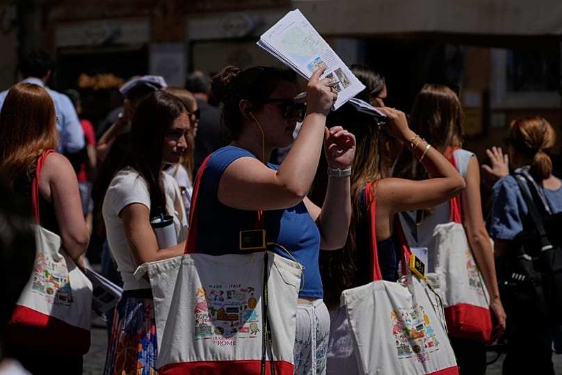 People attempting to shelter from the scortching sun in Rome on 26th May 2026