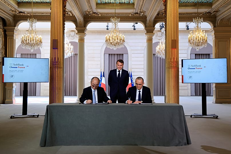 France's President Emmanuel Macron watches Schneider Electric CEO and CEO of SoftBank Group Corp. sign agreements in Paris, 1 June, 2026
