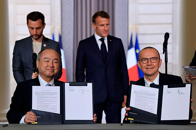 France's President Emmanuel Macron watches Schneider Electric CEO and CEO of SoftBank Group Corp. sign agreements in Paris, 1 June, 2026