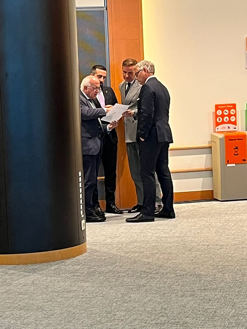 EU Home Affairs Commissioner Magnus Brunner discussing with Parliament's and Council's representatives outside the room