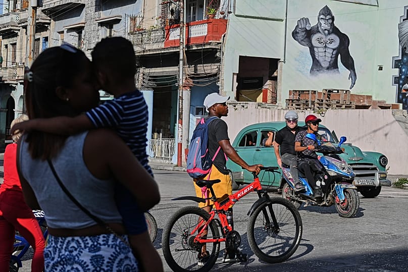 People traverse a street in Havana, Monday, May 25, 2026. (AP Photo/Jorge Luis Banos)