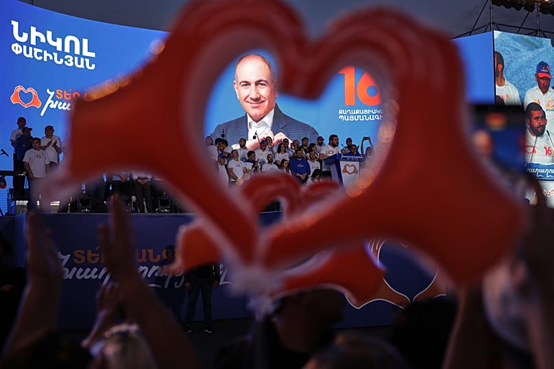 Supporters of Armenia's ruling Civil Contract party leading by Prime Minister Nikol Pashinyan hold up heart signs while gathering in Republic Square in Yerevan, 5 June 2026