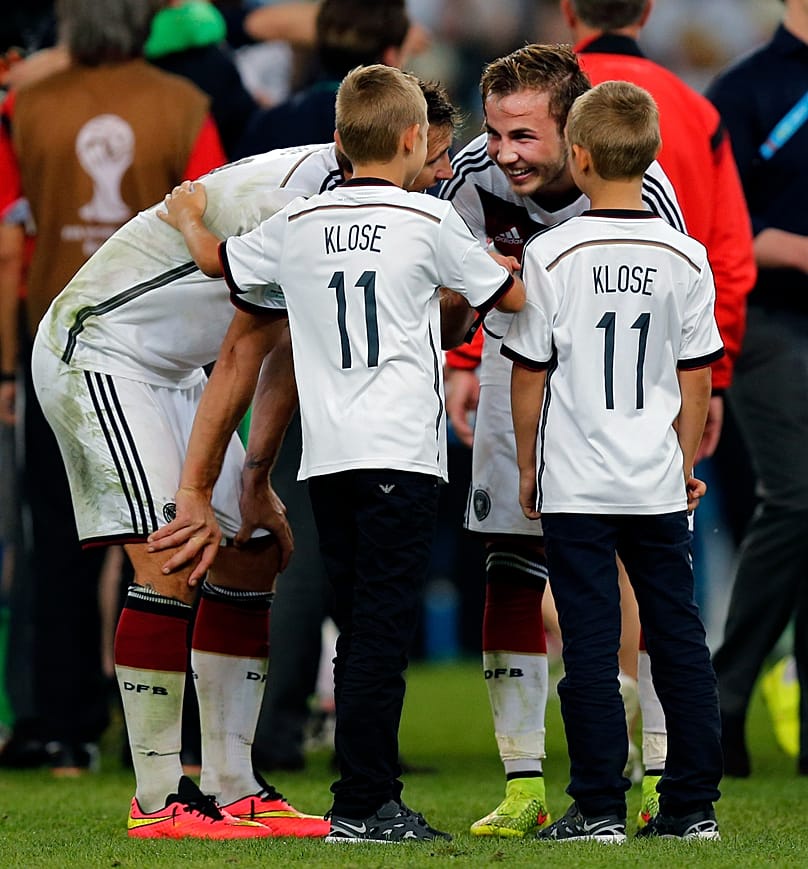 Footballer Mario Götze talks to the children of his team-mate Miroslav Klose after the World Cup final between Germany and Argentina in July 2014.
