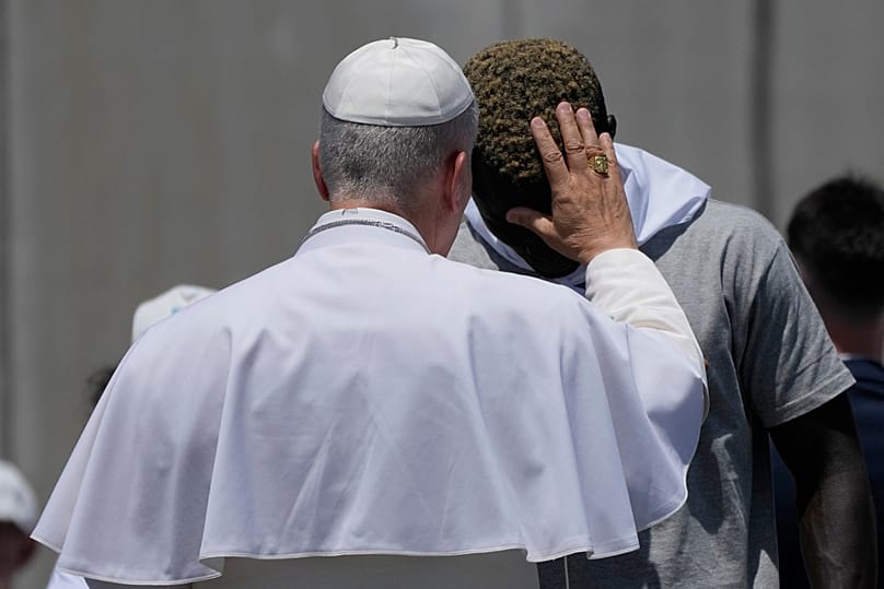 Pope Leo XIV blesses a migrant during a meeting with organisations working with migrants in Arguineguin at the Canary Islands, Spain, Thursday, June 11, 2026.