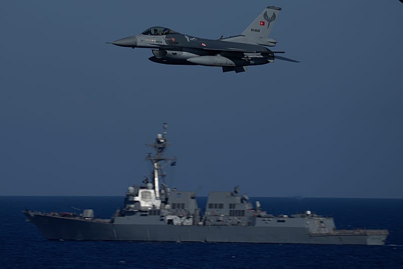A Turkish F16 fighting jet flies over naval ships during an annual NATO naval exercise in the Mediterranean, 15 September, 2022