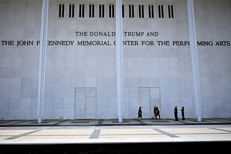 People walk under the sign at The John. F. Kennedy Center for the Performing Arts in Washington, 7 June, 2026