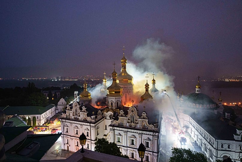 Rescue workers try to put out a fire at the Dormition Cathedral of thousand-year-old Monastery of Caves, also known as Kyiv Pechersk Lavra, following a Russian strike on Kyiv,