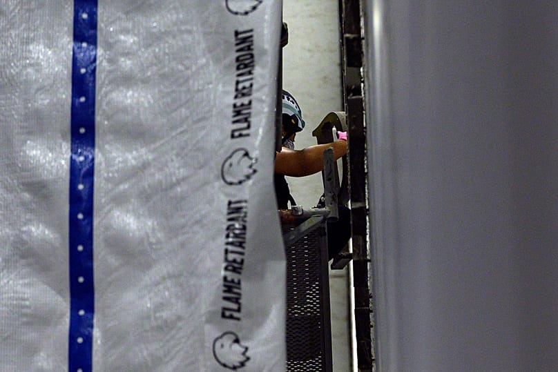 A worker removes a letter from Donald Trump's name from the wall of the John F. Kennedy Center - 13 June 2026