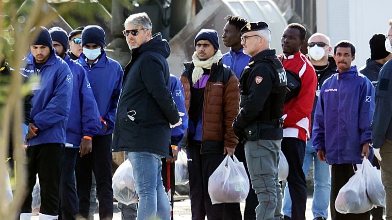 Migrants follow the authorities after their arrival in the port of Shengjin, northwestern Albania, Jan. 28, 2025. (AP Photo/Vlasov Sulaj, File)