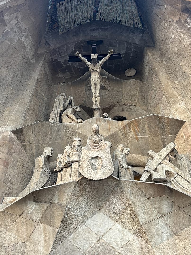 Rear façade of the Sagrada Familia showing a crucified Christ. Bottom left, an image of Gaudí and a soldier who inspired 'Star Wars'.