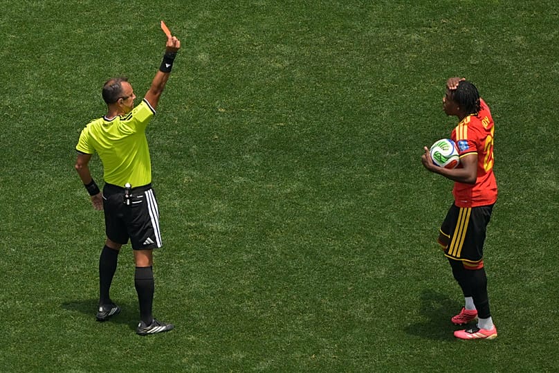 Referee Dario Herrera shows a red card to Belgium's Nathan Ngoy during the World Cup Group G match in Inglewood, California, near Los Angeles, Sunday, June 21, 2026