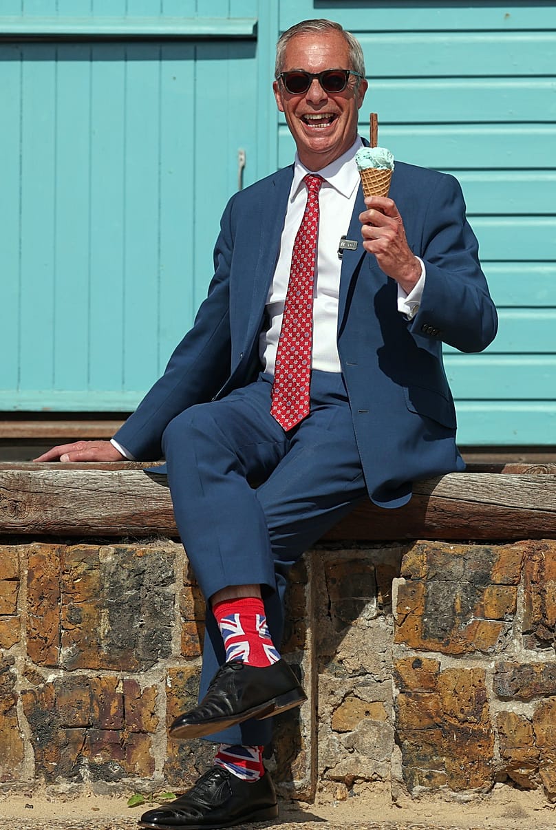 Britain's Reform Party leader Nigel Farage poses for photographers on the beach after casting his vote at a polling station in Walton on the Naze, UK, 7 May 2026