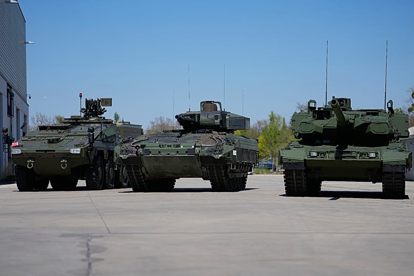 A boxer armoured personnel carrier, a Puma infantry fighting vehicle and a Leopard battle tank are displayed in Munich by pan-European defence company KNDS, 22 April 2026