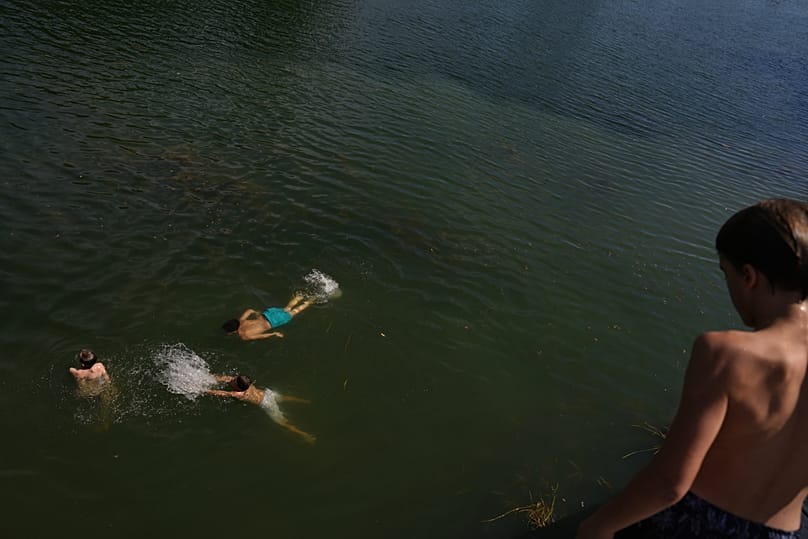 Young boys swim in the Seine in Samois-sur-Seine, south of Paris, on 19 June 2026
