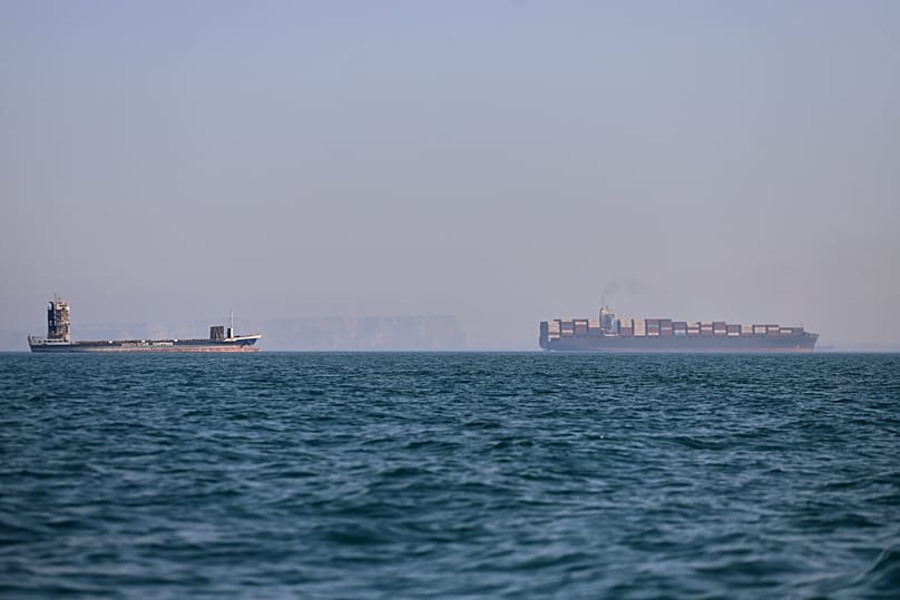 A container ship, right, and a cargo vessel are seen in the Strait of Hormuz off Bandar Abbas, Iran, Wednesday, June 17, 2026. 